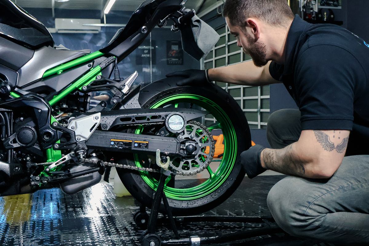 Motorbike wheel being hand cleaned
