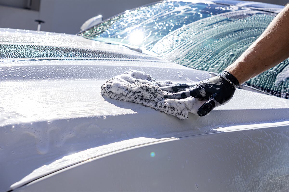 Wash mitt gliding over white paint